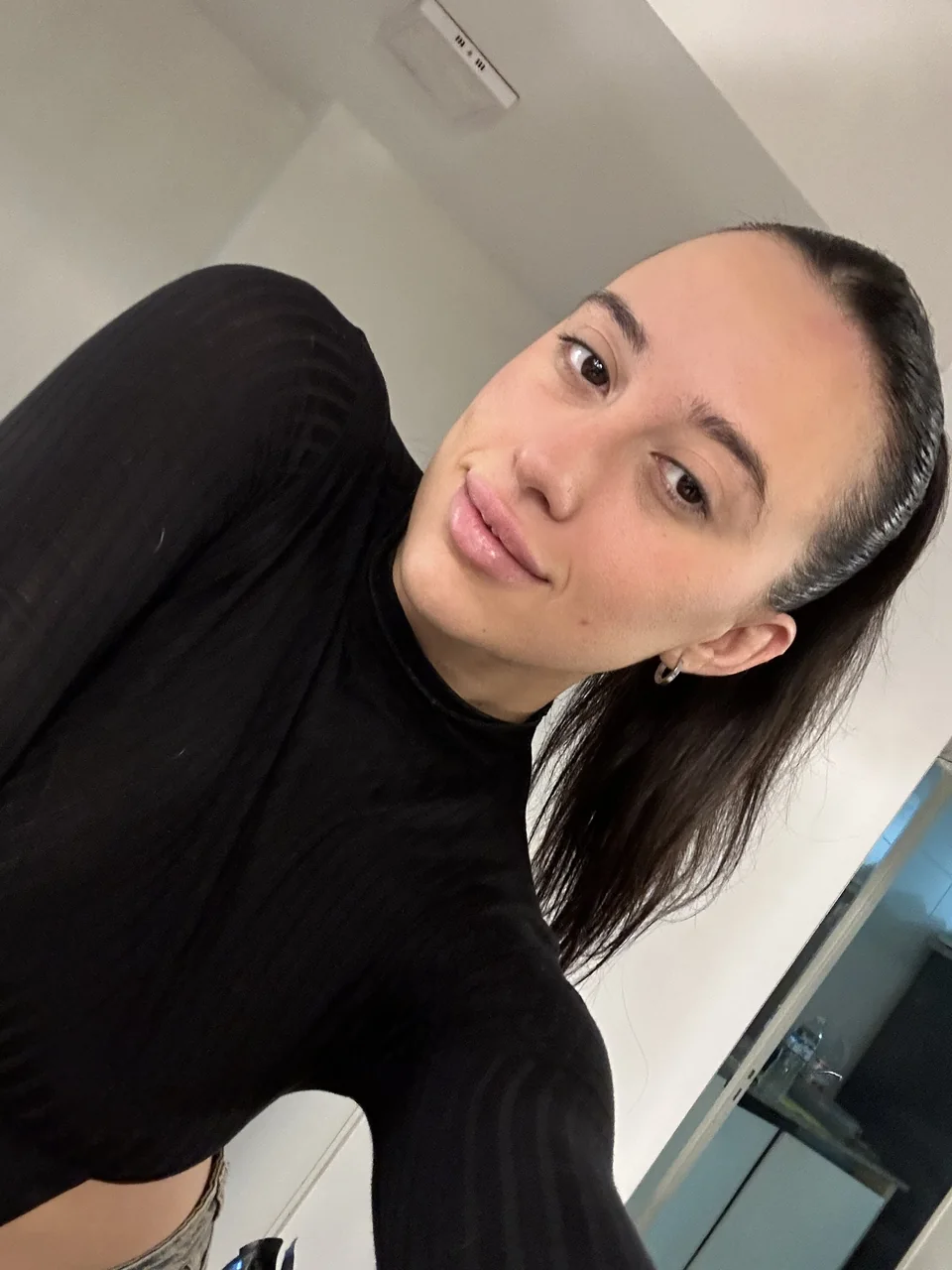 Natalye in a black top with her hair tied back